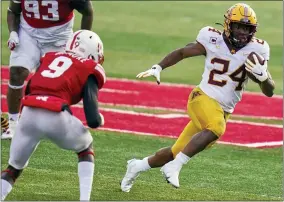  ?? NATI HARNIK - THE ASSOCIATED PRESS ?? FILE - In this Dec. 12, 2020, file photo, Minnesota running back Mohamed Ibrahim (24) carries the ball away from Nebraska safety Marquel Dismuke (9) during the second half of an NCAA college football game in Lincoln, Neb.