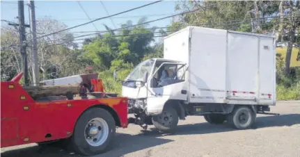  ?? (Photo: Kasey Williams) ?? A wrecker removes a truck from the scene of a crash on New Green Road in Mandeville, yesterday.