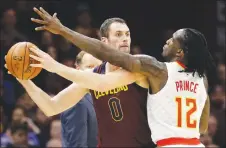  ?? CP PHOTO ?? Cleveland Cavaliers’ Kevin Love looks to pass against Atlanta Hawks’ Taurean Prince in the first half of an NBA game in Cleveland.
