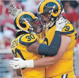  ?? TONY AVELAR THE ASSOCIATED PRESS ?? Todd Gurley II (30) celebrates a touchdown with offensive tackle Rob Havenstein.