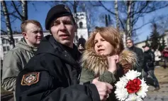  ?? — AFP photo ?? Belarus police detain an opposition supporter holding flowers during an opposition rally in Minsk.