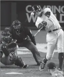  ?? FRANK FRANKLIN II, THE ASSOCIATED PRESS ?? The Yankees’ Aaron Judge hits a homer during the seventh inning of Game 4 against the Houston Astros on Tuesday night in New York in a 6-4 victory. PETE CALDERA