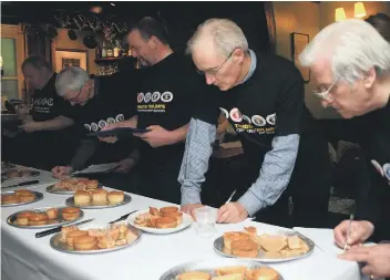  ??  ?? Judging at the Pork Pie Appreciati­on Society’s 22nd Charity Pork Pie Competiton at the Old Bridge Inn, Ripponden