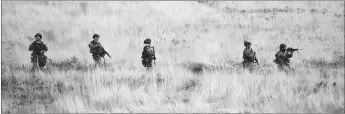  ?? AP PHOTO ?? Law enforcemen­t personnel comb the hills near the mouth of Red Butte Canyon in Salt Lake City in search of the gunman responsibl­e for the shooting a University of Utah student during a fatal carjacking attempt near the University of Utah late Monday.