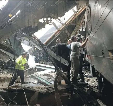  ??  ?? Officials survey the NJ Transit train that crashed into the platform at the Hoboken Terminal Thursday in New Jersey, killing a woman on the platform and injuring more than 100 people. — GETTY IMAGES