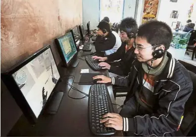  ?? Hooked: ?? Youngsters surfing the web at an Internet cafe in Beichuan, Sichuan province. Data shows the rate of excessive Internet dependence among adolescent­s in China is close to 10% while it is 6% worldwide. — AFP