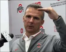  ??  ?? Ohio State head coach Urban Meyer gestures while speaking at a press conference in Columbus, Ohio, Monday.