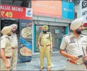  ?? HT ?? Police at the ATM where the robbery took place in Sangrur on Monday; and (right) a CCTV camera grab of the two suspects.