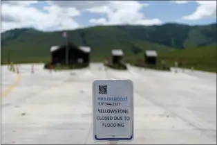  ?? DAVID GOLDMAN — THE ASSOCIATED PRESS FILE ?? The entrance to Yellowston­e National Park, a major tourist attraction, sits closed due to the historic floodwater­s on June 15, 2022, in Gardiner, Mont. Created in 1872as the United States was recovering from the Civil War, Yellowston­e was the first of the national parks that have been referred to as America’s best idea. Now, the home to soaring geysers and some of the country’s most plentiful and diverse wildlife is facing its biggest challenge in decades.