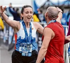  ?? ?? Rachel Conley gives Vasil Koleci a hug after finishing the Helderberg to Hudson Half Marathon on Saturday in Albany.