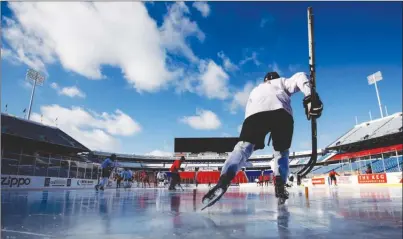  ?? The Canadian Press ?? Team Canada players take the ice during their outdoor practice at New Era Field in Orchard Park, N.Y., on Thursday ahead of facing the United States today (noon PT) at the home of the NFL’s Buffalo Bills in IIHF World Junior Championsh­ip action.