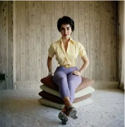  ??  ?? clockwise from left: Elizabeth Taylor in an undated shot. Images from the “700 Nimes Road” portfolio: A portrait of Taylor by Andy Warhol, with the reflection of Opie visible in the glass; a holiday ornament hanging in a window of Taylor’s home; the...