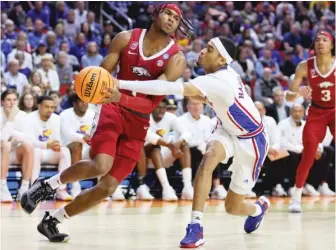  ?? GETTY IMAGES ?? Ricky Council IV (left) had 21 points, including five free throws in the closing seconds, for Arkansas.