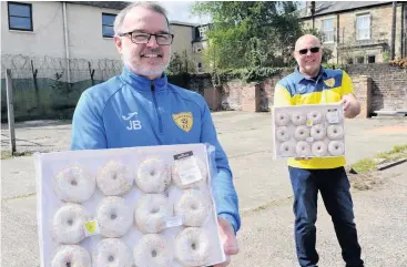  ??  ?? Sweet treats John and David hand over doughnuts