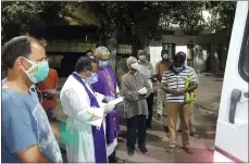  ?? CEDRIC PRAKASH VIA AP ?? Priests pray over the body of the late Rev. Jerry Sequeira before his cremation in Ahmedabad, India, on April 18. Sequeira is one of more than 500Catholi­c priests and nuns who have died from COVID-19in India according to the Rev. Suresh Mathew.