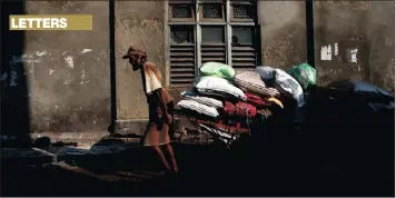  ?? PICTURE: ASSOCIATED PRESS ?? A Sri Lankan labourer pulls a cart in Colombo, Sri Lanka.