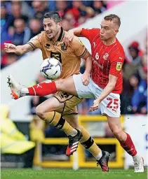  ?? ?? BATTLE: Ben Garrity battles Swindon Town’s Louis Reed.