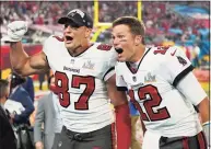  ?? Ashley Landis / Associated Press ?? Tampa Bay Buccaneers tight end Rob Gronkowski, left, and quarterbac­k Tom Brady celebrate after defeating the Kansas City Chiefs in the Super Bowl 55 on Feb. 7 in Tampa, Fla.