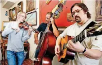  ?? [OKLAHOMAN ARCHIVES PHOTO] ?? Horseshoe Road violinist Kyle Dillingham, left, plays an impromptu tune with fellow band members Brent Saulsbury and Brad Benge in February. The band joined Canterbury Voices last week for “Bluegrass and Blue Jeans.”