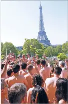  ?? NEW YORK TIMES OWEN FRANKEN ?? Nudists raise their glasses in a toast Saturday during a reception on a balcony at the Palais de Tokyo art museum in Paris. The museum held a special tour of exhibits for nude visitors only.