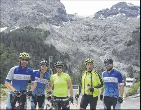  ??  ?? Cyclists who participat­ed in the recent Give to Live Big Ride 2018 in the Eastern Alps are seen during a stop as they neared the top of the tree line heading up to the Stelvio Pass. From left are teammates Evan Maceachern, Shawn Dale, Meg Macdougall, Chris Macdougall and Dustin Linden. At right, with the daunting summit of the Stelvio Pass of the Eastern Alps looming in the distance, Chris takes a short break.