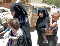  ?? AFP ?? Displaced women walk towards Iraq forces as they flee their homes in Mosul’s western Al Shifa district on Thursday during the ongoing offensive against Daesh group fighters. —