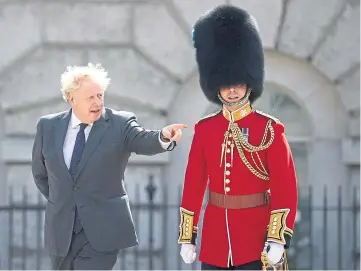  ??  ?? LOOK SMART: Boris Johnson inspects a guard of honour for Abu Dhabi’s crown prince.