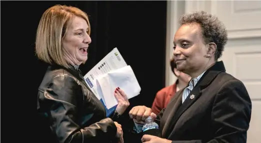  ?? PAT NABONG/SUN-TIMES ?? Mayor Lori Lightfoot (right) chats with DuPage County Board Chair Deborah Conroy at the Jan. 4 announceme­nt of a regional growth initiative.