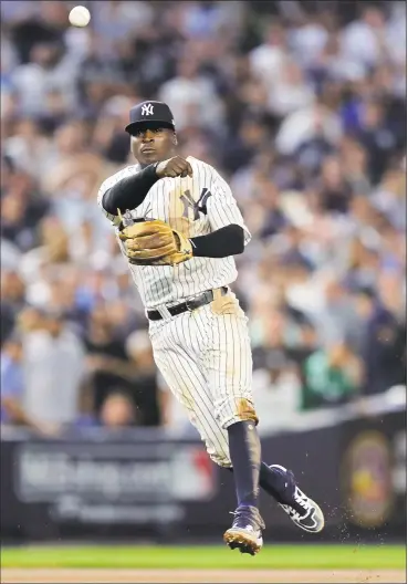  ?? Elsa / Getty Images ?? The Yankees’ Didi Gregorius throws to first base in Game 4 of the AL division series against the Red Sox on Oct. 9 at Yankee Stadium.