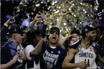  ?? BRYNN ANDERSON — THE ASSOCIATED PRESS ?? Connecticu­t players celebrate after the men’s national championsh­ip game against San Diego State in the NCAA Tournament on Monday in Houston.