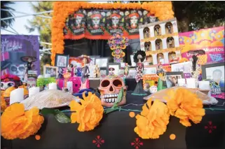  ?? PHOTO BY JOHN VALENZUELA ?? Altars for rememberin­g dead loved ones are common at Dia de los Muertos celebratio­ns like this one at Riverside’s White Park last year. This year’s event returns Nov. 4.