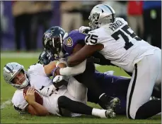  ?? ROB CARR — GETTY IMAGES ?? Raiders quarterbac­k Derek Carr is sacked by linebacker Matt Judon, who took the signal-caller down on three straight plays in the fourth quarter.