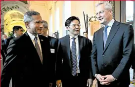  ?? ?? DISARMING PERSONALIT­Y Wong, center, speaks with French minister Bruno Le Maire, right, at an event in Paris on April 10.