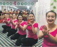  ?? Reuters ?? Residents of what China calls a vocational skills centre in Xinjiang perform for visiting government officials