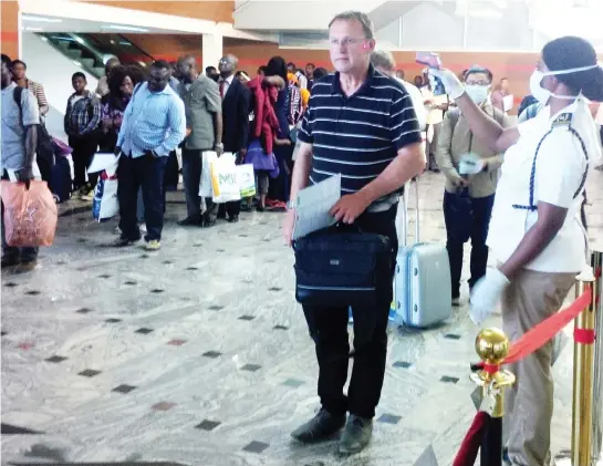  ?? PHOTO Daniel Adugbo ?? Passengers being screened for possible Ebola symptoms at the Nnamdi Azikiwe Internatio­nal Airport,
Abuja, yesterday.