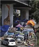  ?? Photograph: Ben Margot/AP ?? A homeless encampment under a freeway overpass in Oakland, California.