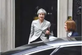  ?? — AFP ?? LONDON: Britain’s Prime Minister Theresa May leaves 10 Downing Street in central London yesterday, ahead of a planned trip to Paris to meet the French president and following a meeting with the leadership of the Democratic Unionist Party (DUP).