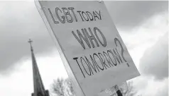  ??  ?? A gay-rights supporter holds up a sign recently against a proposed constituti­onal amendment that would prohibit penalties against those who decline to provide wedding-related services to same-sex couples based on religious beliefs, in Jefferson City, Mo.