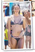  ?? BAKING: Thousands of beachgoers sought relief from Sydney’s heat at Bondi yesterday. LEFT: Balia Hernandez cools off under a shower. ??