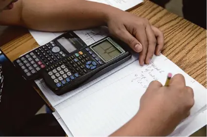  ?? Paul Chinn/The Chronicle 2015 ?? Huy Do solves a math problem in an advanced placement calculus class at Burton High School in San Francisco. Teaching algebra in the eighth grade gives students a chance to take calculus by the time they are seniors.