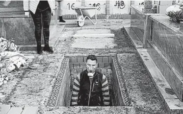  ?? BERNAT ARMANGUE/AP ?? An undertaker prepares Rosalía Mascaraque’s grave Wednesday in Zarza de Tajo, Spain. She died in the pandemic.