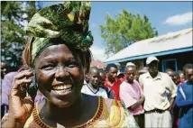  ?? AP PHOTO / KAREL PRINSLOO ?? Kenyan environmen­tal activist Wangari Maathai speaks on the phone in October 2004 in the Ihururu settlement near Nyeri, Kenya, as she is congratula­ted on winning the Nobel Peace Prize for her work as leader of the Green Belt Movement.