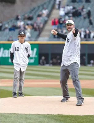  ?? ERIN BROWN/ SUN- TIMES ?? Former White Sox catcher A. J. Pierzynski throws out the first pitch at the Sox’ home opener Thursday at Guaranteed Rate Field.
