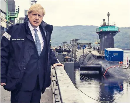  ??  ?? Mr Johnson views a submarine at HM Naval Base Clyde, the home of the UK’s nuclear defence, yesterday