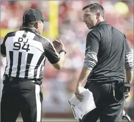  ?? TONY AVELAR — THE ASSOCIATED PRESS ?? 49ers coach Kyle Shanahan talks with head linesman Hugo Cruz during the second half of the game against Carolina on Sunday. It was an emotional day for the 49ers’ new boss.