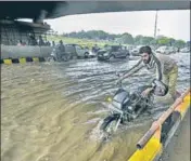  ??  ?? A man pushes his motorcycle across a water-logged stretch near AIIMS in New Delhi on Saturday. BIPLOV BHUYAN/HT PHOTO
