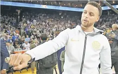  ?? — AFP photo ?? Stephen Curry shows his 2017-2018 Championsh­ip ring prior to their game against the Oklahoma City Thunder at ORACLE Arena in Oakland, California.