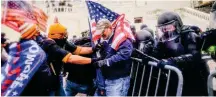  ??  ?? Pro-Trump rioters try to force their way past a cordon of riot police trying to prevent their entry into the US Capitol in Washington, DC, on January 6.