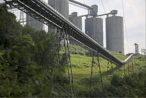  ?? Jessie Wardarski/Post-Gazette ?? A conveyor at Consol Energy’s Bailey Mine in Waynesburg, Greene County, sits dormant atop a line of trees in August 2018.