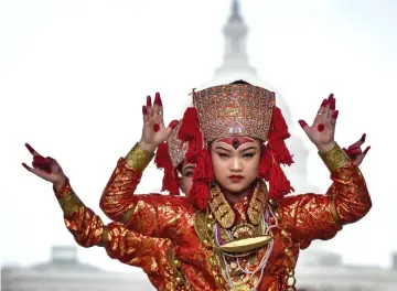  ??  ?? Members of Nritya Mandap perform a Nepali dance with the Capitol as a backdrop at Fiesta Asia.